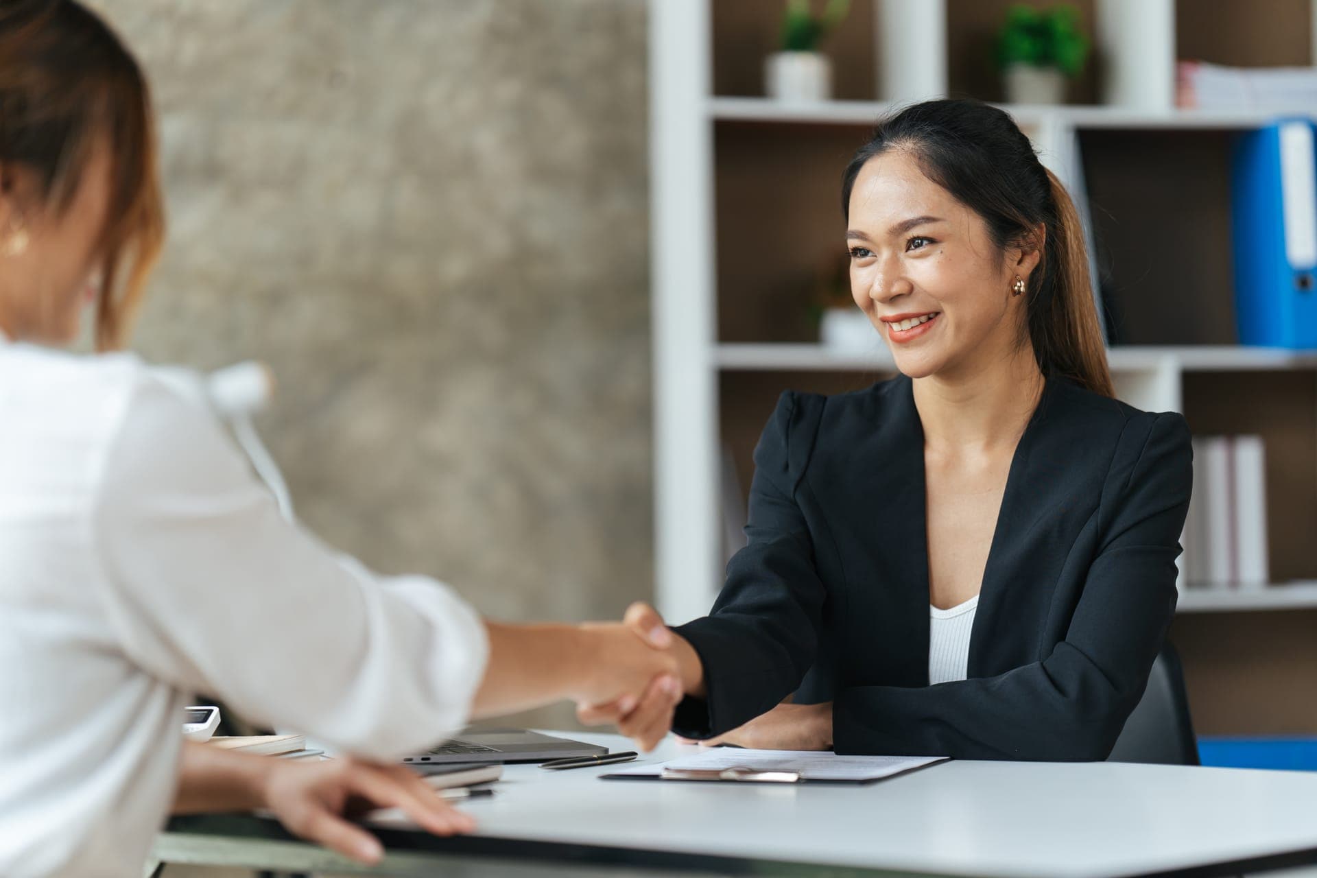 Business professionals shaking hands in a meeting
